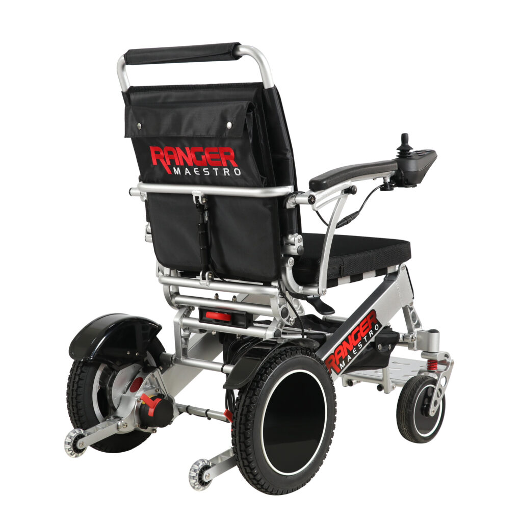 Ranger Maestro reclining folding power wheelchair, angled rear view from the right with joystick