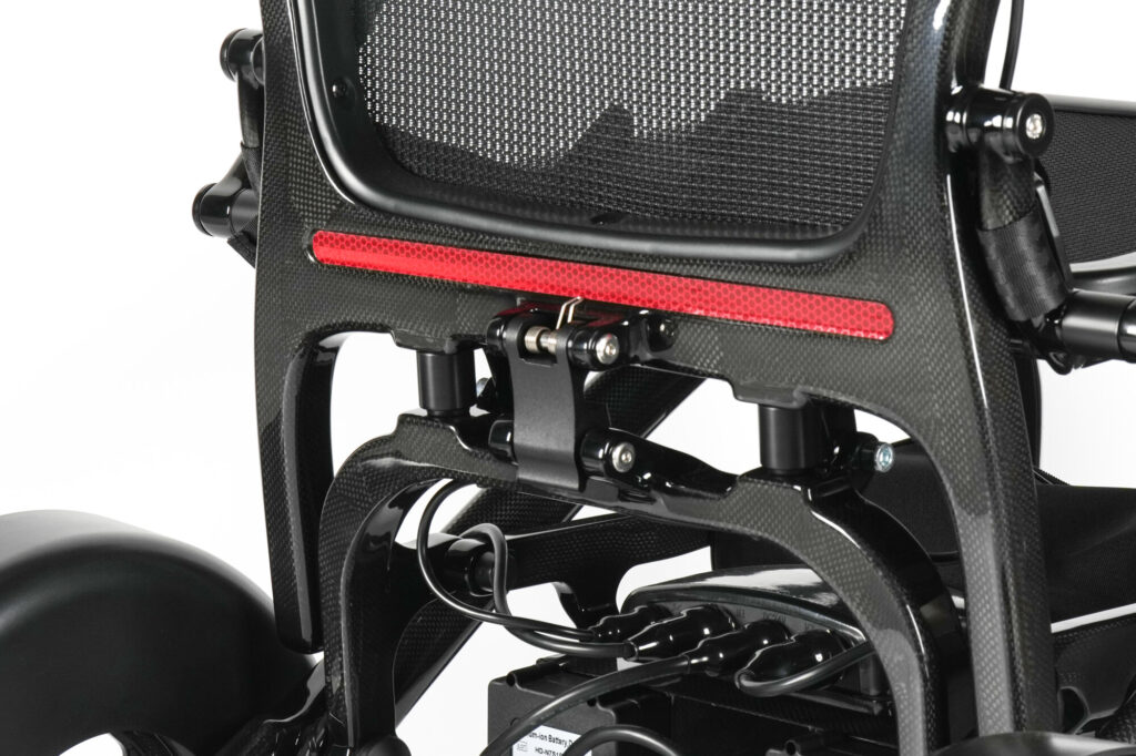 Porto Mobility Ranger TorqueLite folding power wheelchair, back frame with red reflector strip and latch close up