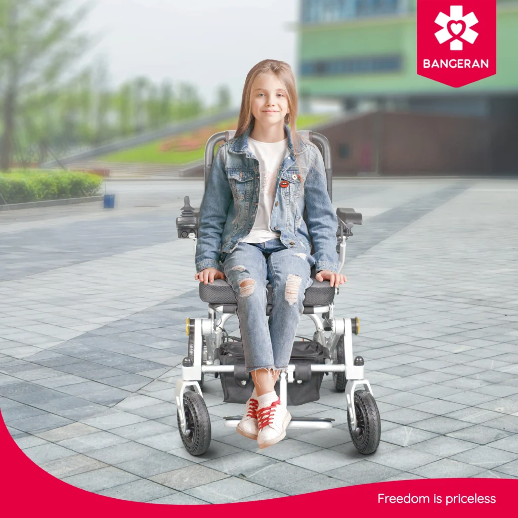 Girl smiling while sitting on Bangeran Pegasus lightweight folding power chair outdoors.