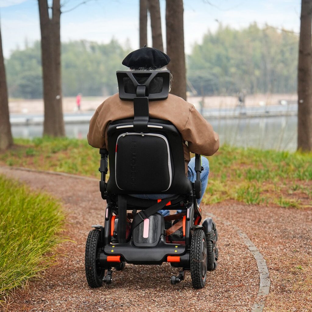 Rider on a Robooter E60 Pro GT along a park path, seen from behind